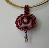 Pretty pink glass bead wrapped in pink wire