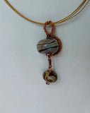 Beautiful coffee shades of  lampwork wrapped in copper