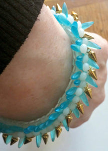 spikey gold,blue, and white glass hand beaded bracelet
