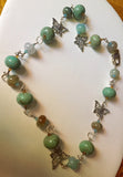 Lovely blends of agate crackle finish turquoise necklace.  Silver tone & Swarovski accents 23"