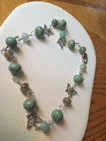Lovely blends of agate crackle finish turquoise necklace.  Silver tone & Swarovski accents 23"